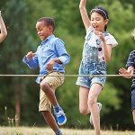 Kindergruppe rennt mit viel Spaß durch ein Ziel